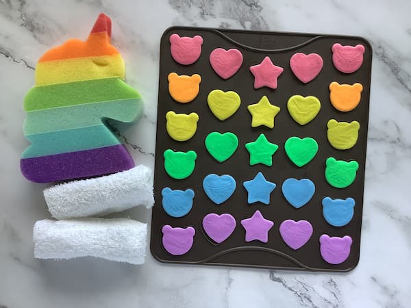 a macaron mat filled with rainbow coloured melt and pour soap
