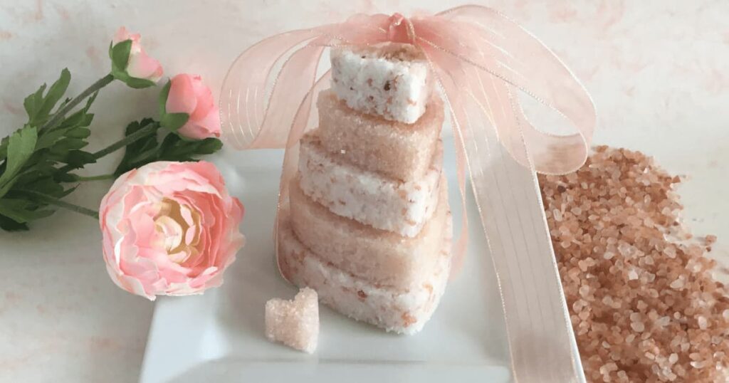 a stack of heart shaped pink himalayan bath salt cakes with a ribbon on top