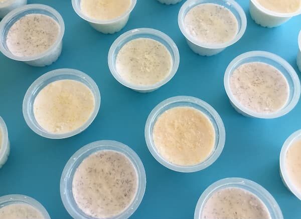 plastic fruit cups filled with bath bomb mixture decorated with colored epsom salts