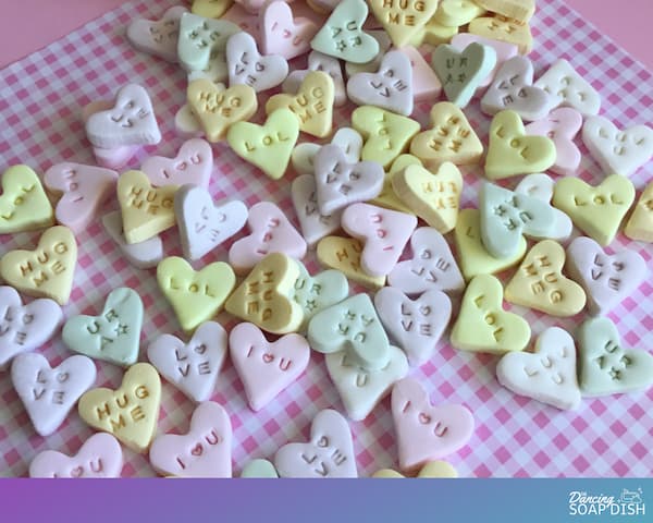 conversation heart style candies laid out on a pink gingham background