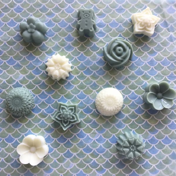 white and blue essential oil lotion bars in assorted floral shapes