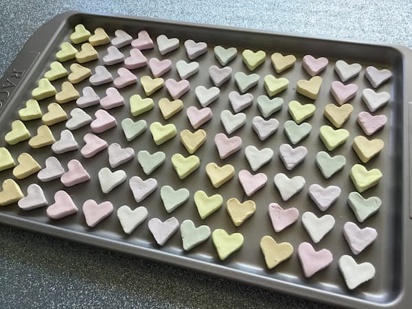 homemade conversation hearts laid out on a tray to dry