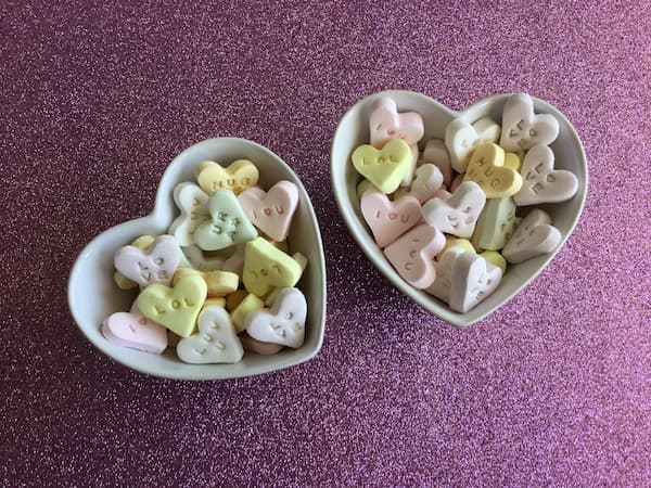 homemade conversation hearts in two heart-shaped bowls