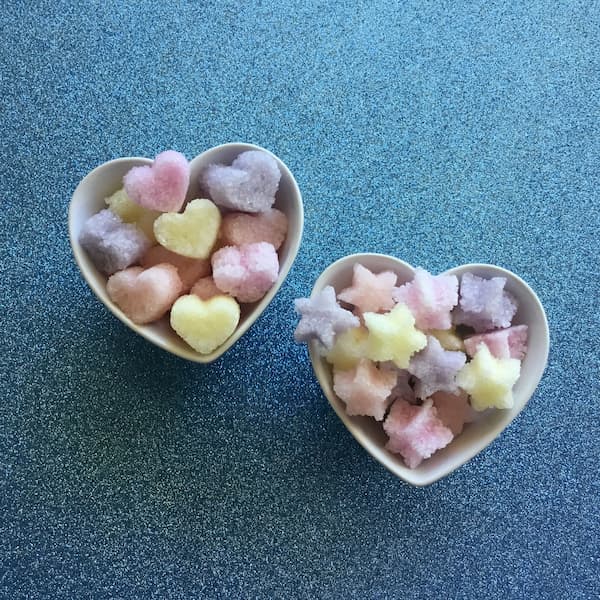pastel pink, yellow, orange and purple heart and star-shaped gems made from Epsom salt