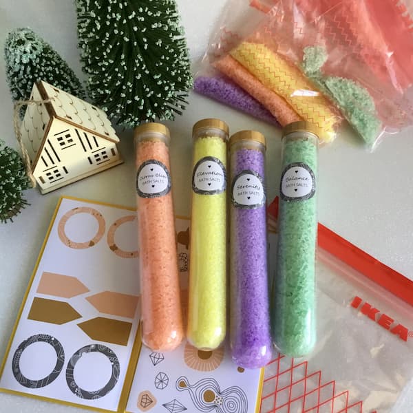 orange, yellow, purple and green dyed bath salts in glass tubes