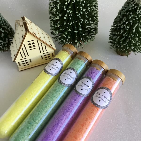 glass tubes filled with colored bath salts in yellow, green, purple and orange