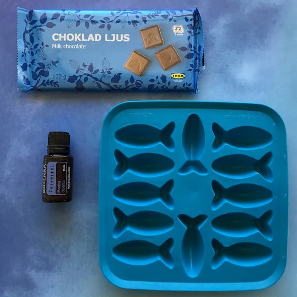 ikea milk chocolate and ikea fish-shaped ice tray with a bottle of doterra peppermint essential oil
