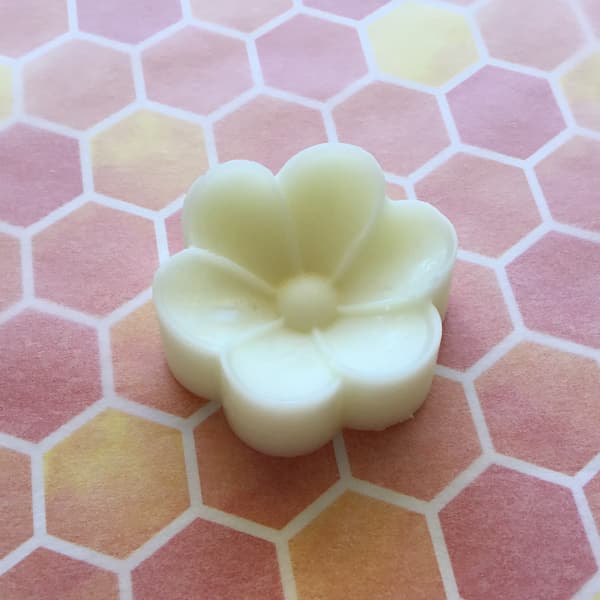 essential oil lotion bar in the shape of a begonia flower
