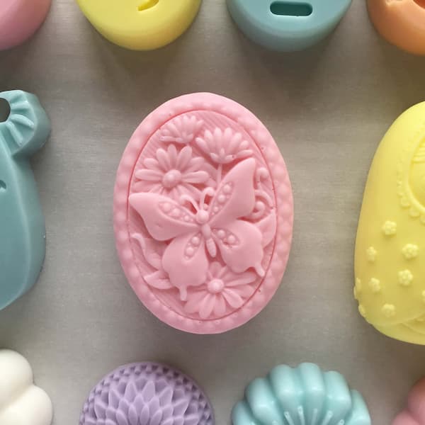 pink bar of soap with picture of butterfly on background of daisies