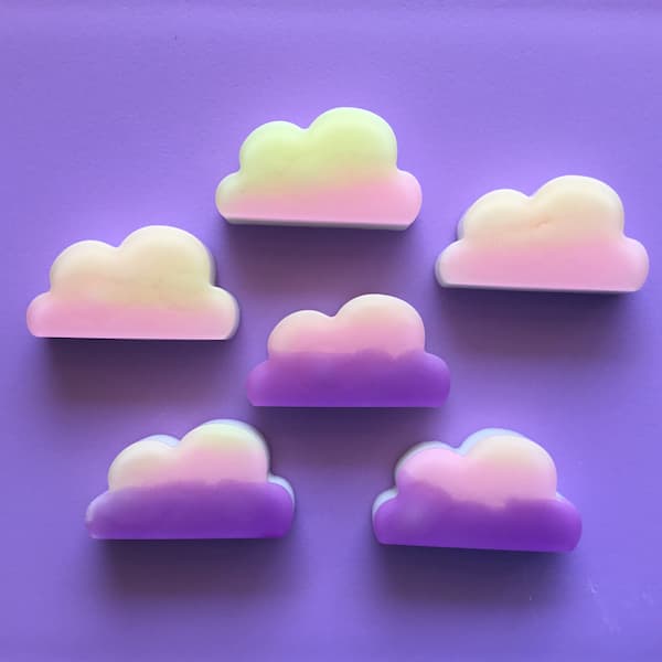 purple, pink, yellow and orange coloured cloud shaped soap on a purple background