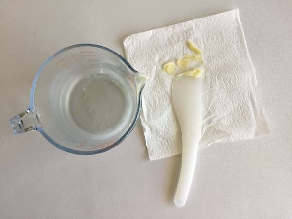 empty glass jug sitting next to paper towel and spatula