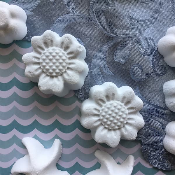 two pale blue sunflower shaped bath bombs