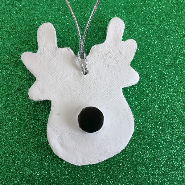 back of clay reindeer with embedded cap