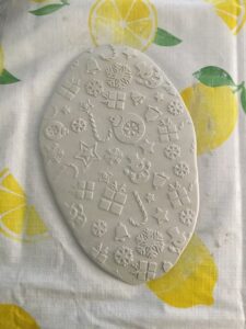 white clay rolled out and embossed with a Christmas theme