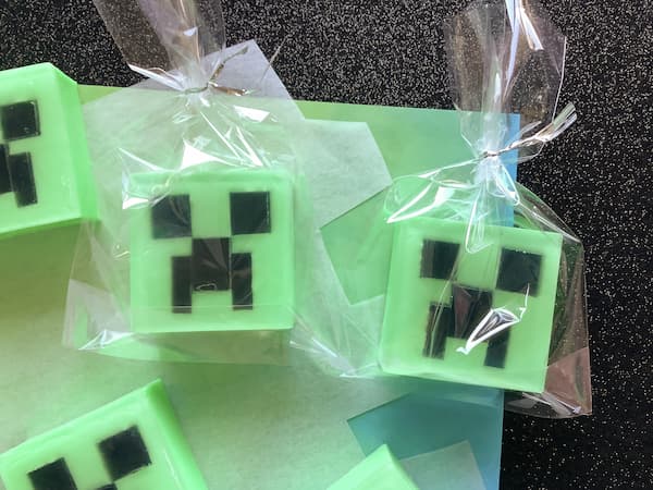 two minecraft creeper soap bars in cellophane bags