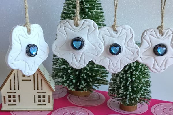 four hanging white clay essential oil diffuser ornaments with embedded 1ml glass vials