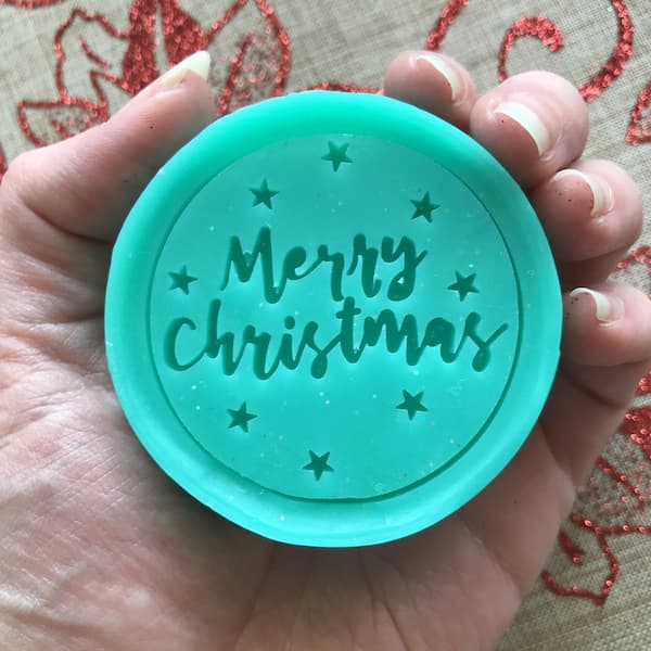 round green bar of soap with the words "Merry Christmas" embossed on the front
