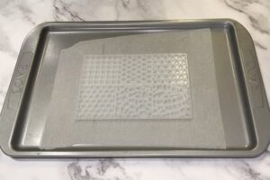 a mosaic tile silicone mould sitting on a paper-lined tray
