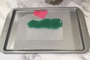 green soap base sitting in a mosaic tile silicone mould