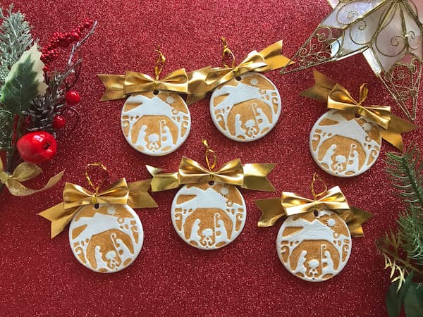 gold stamped nativity ornaments with gold bows