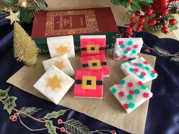 a collection of nine square mosaic soap bars with three different Christmas designs