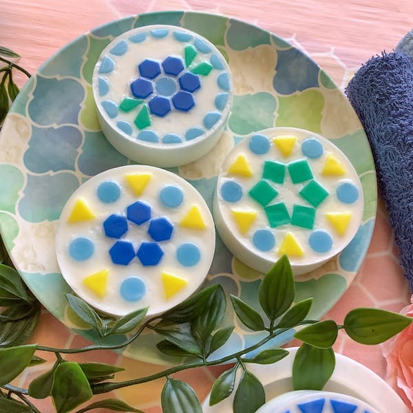 three basic mosaic soap bars sitting on a decorative plate