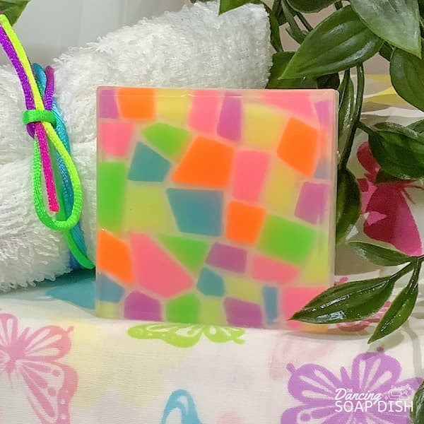 a square soap bar covered with neon coloured mosaic tiles