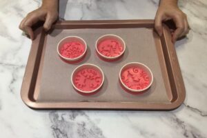 four silicone ornament moulds with fitted paper cup rings sitting on a tray