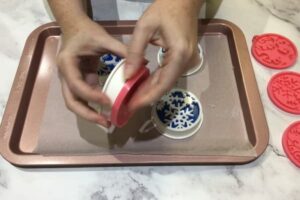 two hands demoulding a bar of soap