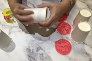 using a paper template to mark up a paper cup