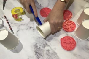 cutting a paper cup with a retractable craft knife
