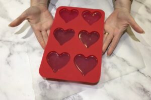 a six cavity heart-shaped soap mould filled with soap