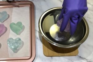 blanching soap bars in a bowl of hot water