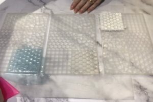 three mosaic tile silicone moulds filled with melt and pour soap