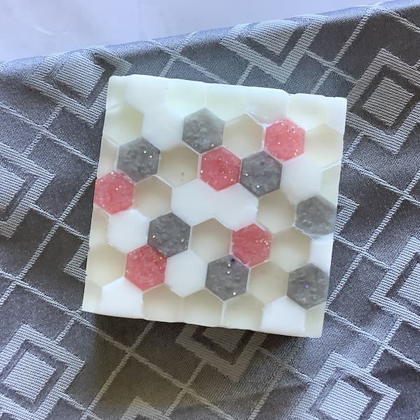 a glass tile effect soap bar with pink and grey highlights