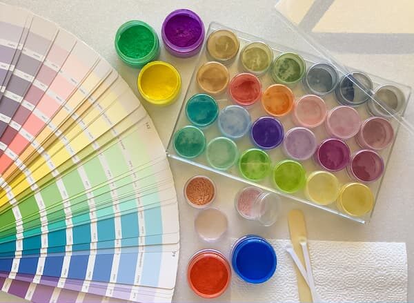 a set of 24 mica colours sitting next to some paint colour swatches