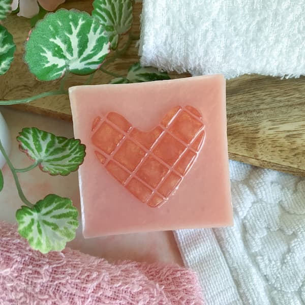 a square soap bar with a rose gold mosaic heart in the centre
