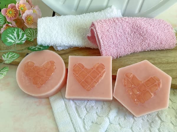three rose gold coloured soap bars with a mosaic tile heart in the centre