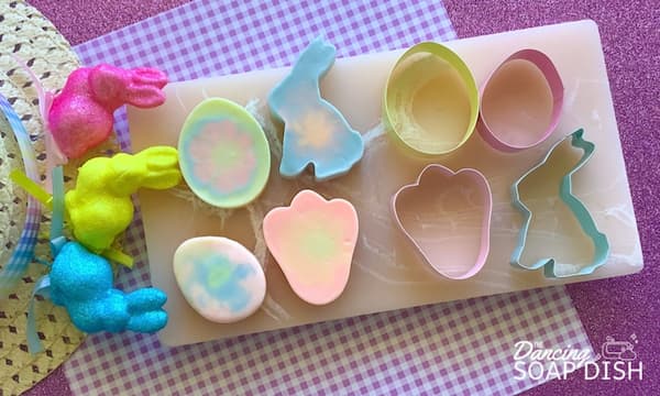 easter shaped soap bars sitting next to easter shaped cookie cutters