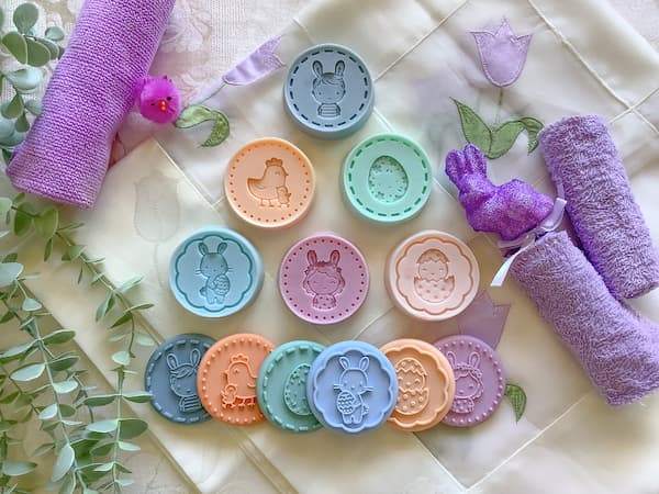 six easter cookie stamps sitting alongside six easter cookie stamp soap bars