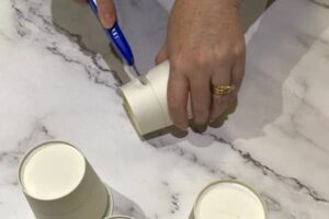 cutting the bottom off a paper up with a craft knife