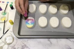using a finger sponge to apply mica paint to a bar of soap