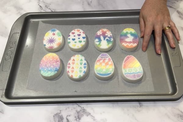 eight easter egg soap bars painted with mica paint in a rainbow pattern