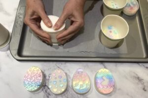 releasing an egg shaped bar of soap from a paper cup mould