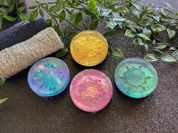 four different coloured embossed mandala soap bars