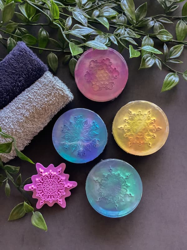 four embossed soap bars with a mandala stamp