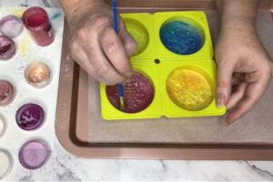 painting the surface of a bar of soap with coloured mica