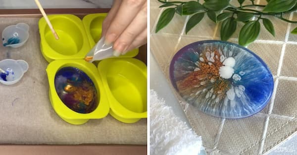 A side‑by‑side collage demonstrating a petri dish resin‑inspired soap technique. On the left, a hand adds colour to clear soap inside a bright green oval silicone mould, creating swirling pools of blue, purple, gold, and white. On the right, a finished oval soap displays a striking organic pattern resembling a petri dish or blooming flower, with radiating streaks of blue, white, copper, and brown spreading from the centre. The soap is presented on a neutral textured surface beside a folded white towel and green foliage.